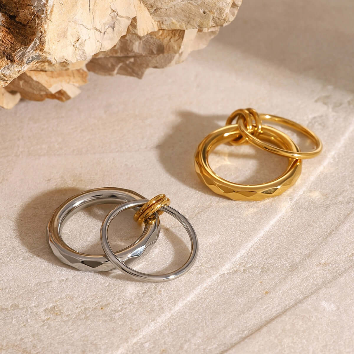 18K gold double-circle interlocking design ring set on a natural stone background, perfect for affordable everyday jewelry.