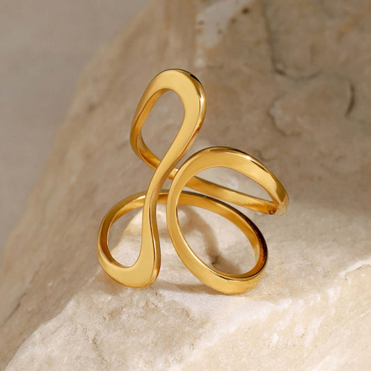 18K gold line design ring on a stone background, perfect for everyday wear and layering with affordable jewelry.
